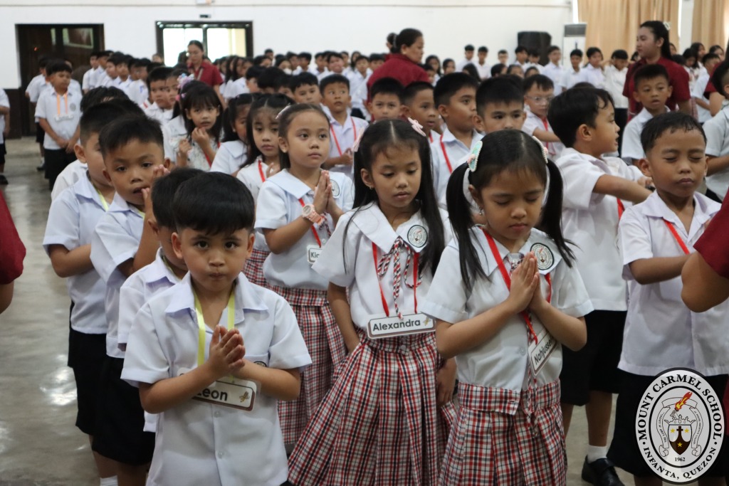 Grade school pupils praying together at a school assembly